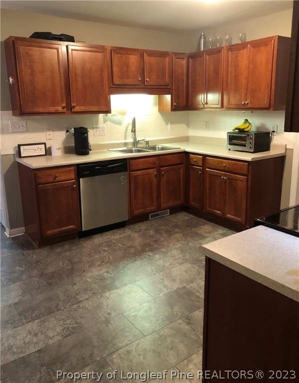 199 Falling Leaf Drive Raeford, NC 28376 - Photo 12 of 38 a kitchen with a sink a stove and cabinets