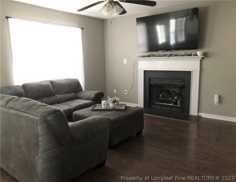 199 Falling Leaf Drive Raeford, NC 28376 - Photo 17 of 38 a living room with furniture a flat screen tv and a fireplace