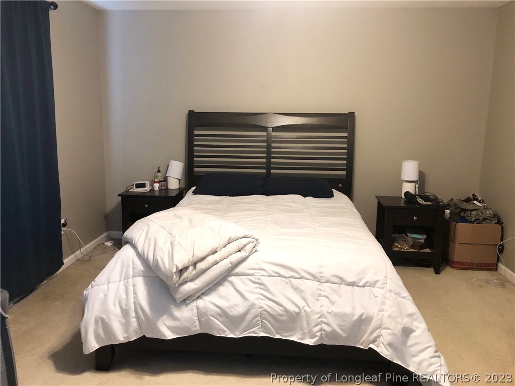 199 Falling Leaf Drive Raeford, NC 28376 - Photo 28 of 38 a bedroom with a bed and dresser
