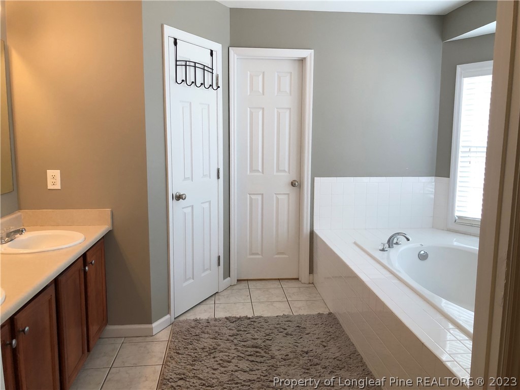 199 Falling Leaf Drive Raeford, NC 28376 - Photo 29 of 38 a bathroom with a bathtub and a shower