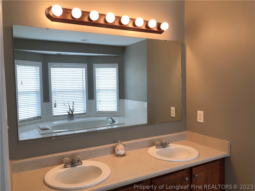 199 Falling Leaf Drive Raeford, NC 28376 - Photo 30 of 38 a bathroom with a sink and a mirror