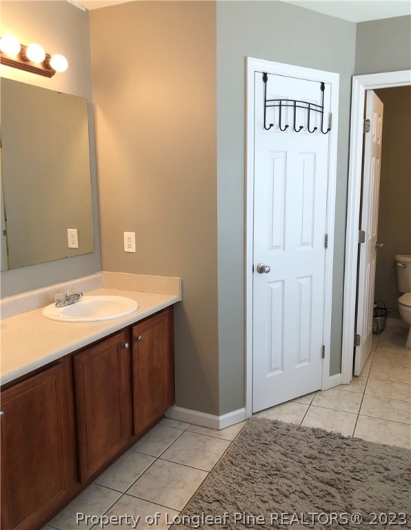 199 Falling Leaf Drive Raeford, NC 28376 - Photo 31 of 38 a bathroom with a sink vanity and a mirror
