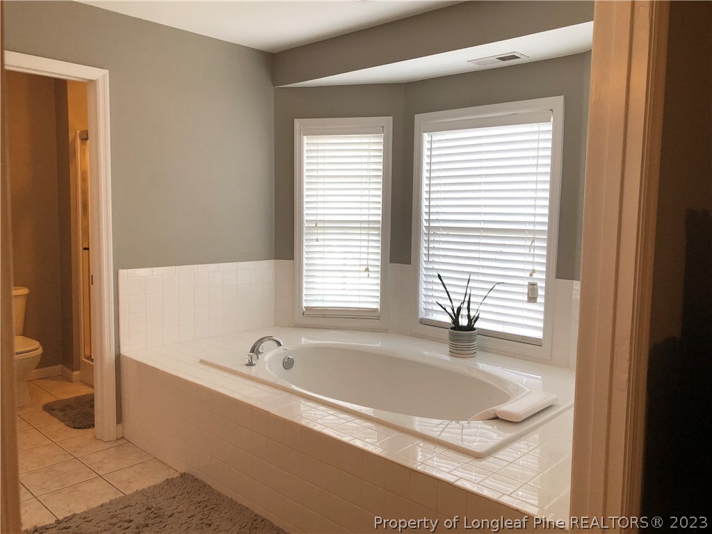 199 Falling Leaf Drive Raeford, NC 28376 - Photo 32 of 38 a white bath tub sitting in a bathroom next to a window