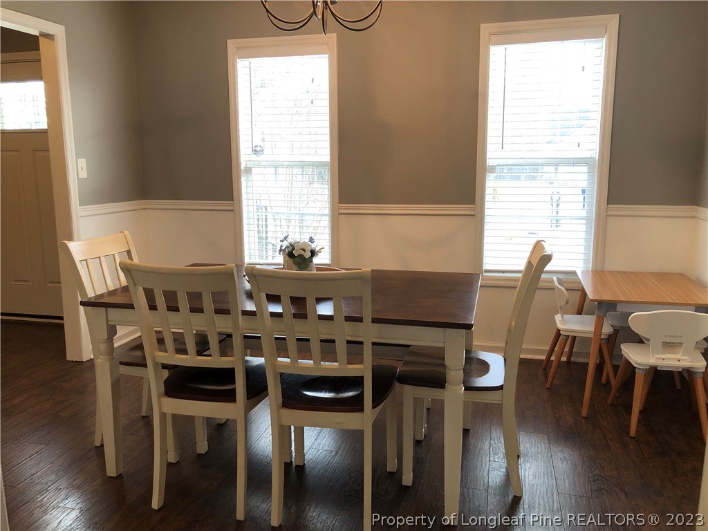199 Falling Leaf Drive Raeford, NC 28376 - Photo 5 of 38 a view of a dining room with furniture and wooden floor
