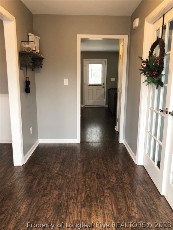199 Falling Leaf Drive Raeford, NC 28376 - Photo 7 of 38 a view of a hallway with wooden floor and a living room