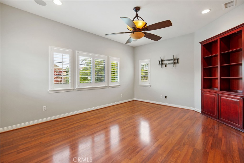 1 Bower Lane Ladera Ranch, CA 92694 - Photo 6 of 40 a view of empty room with wooden floor and fan