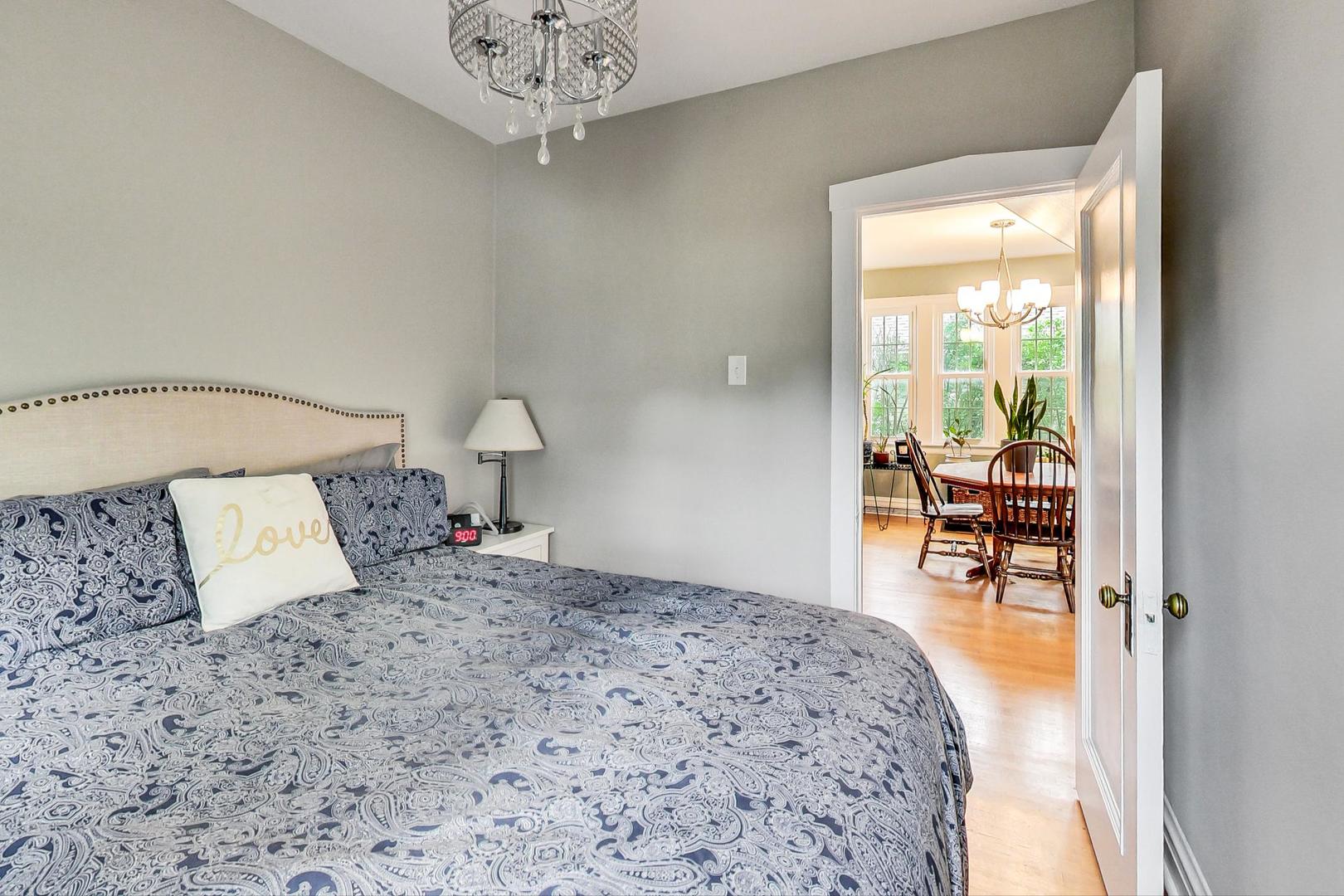 132 East Burlington Street Riverside, IL 60546 - Photo 16 of 38 a bedroom with a large bed and a chandelier