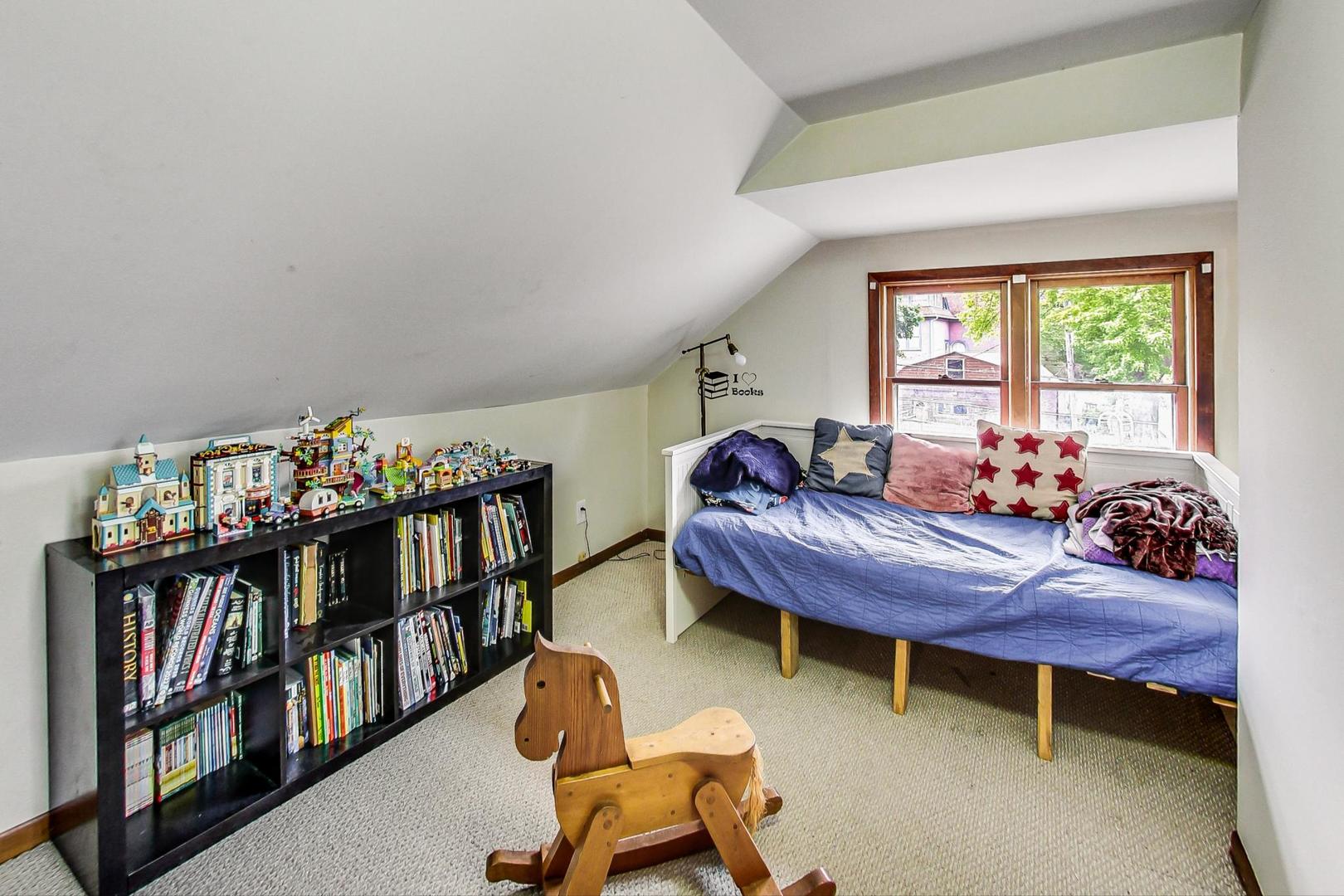 132 East Burlington Street Riverside, IL 60546 - Photo 21 of 38 a bedroom with furniture window and book shelf