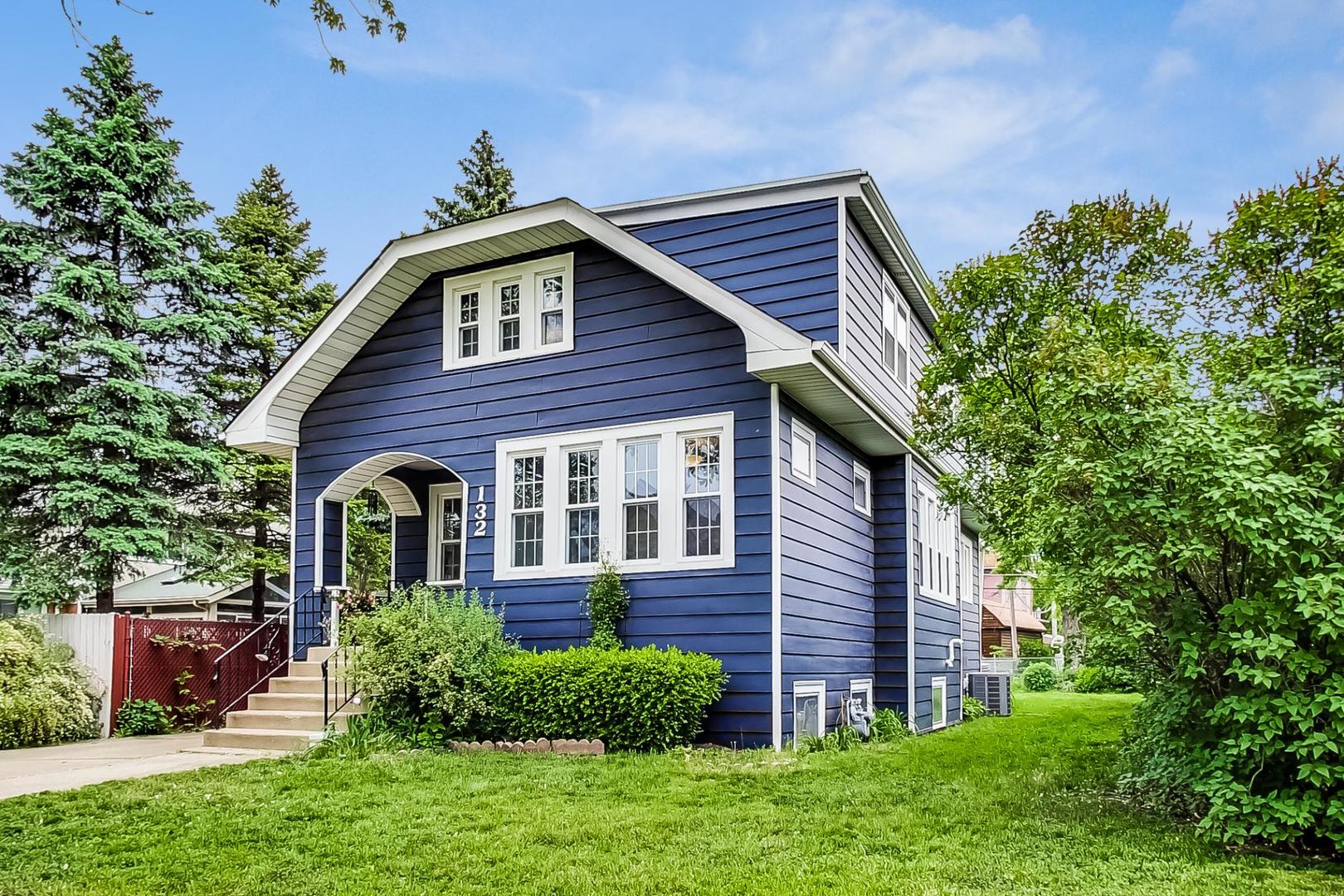 132 East Burlington Street Riverside, IL 60546 - Photo 3 of 38 a view of a house with brick walls and a yard with plants