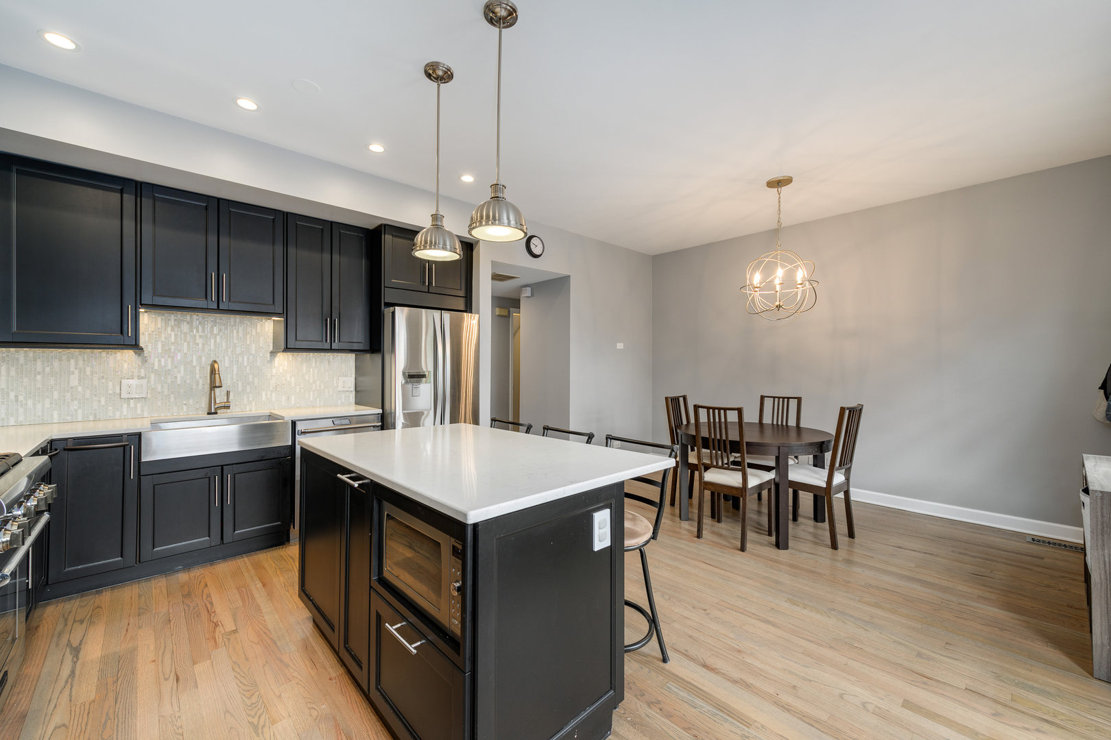 1718 West Huron Street Chicago, IL 60622 - Photo 11 of 33 a kitchen with a table chairs sink and cabinets