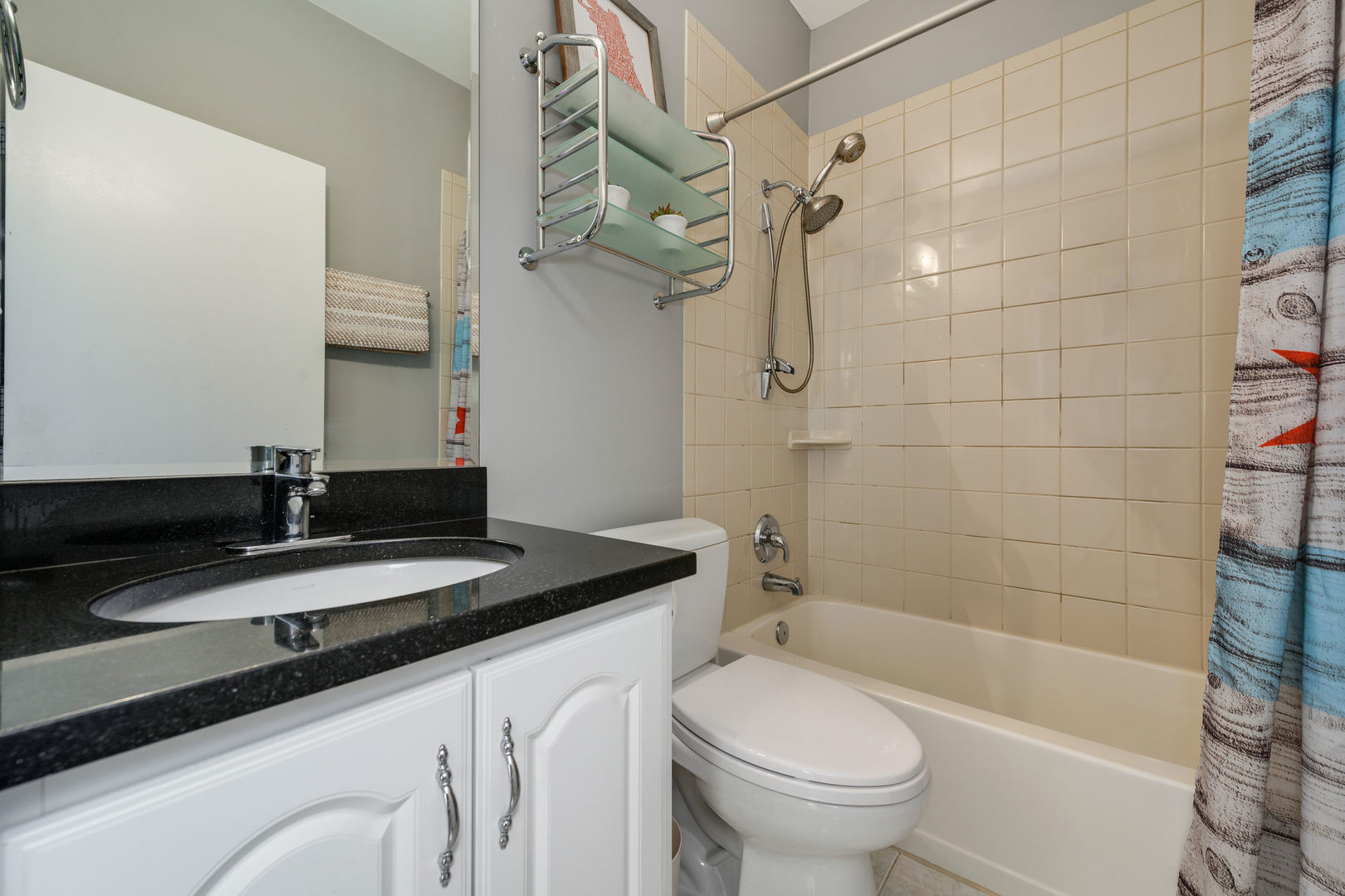 1718 West Huron Street Chicago, IL 60622 - Photo 21 of 33 a bathroom with a granite countertop sink a toilet a mirror and shower