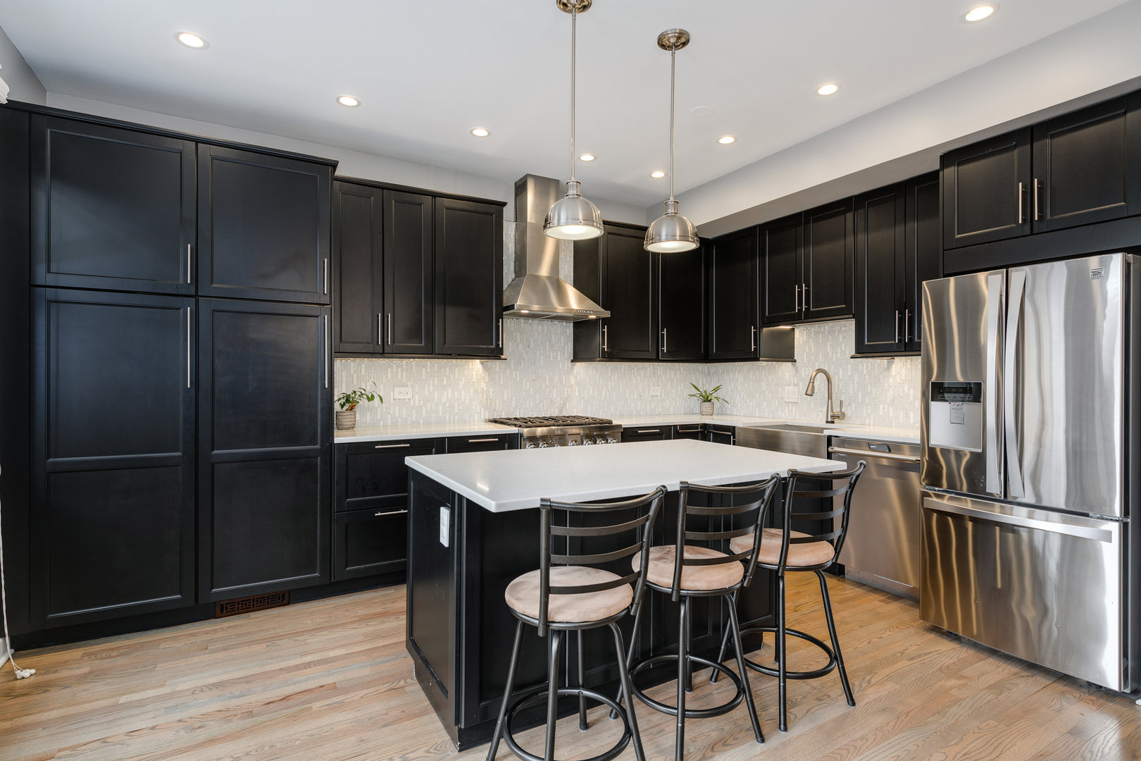 1718 West Huron Street Chicago, IL 60622 - Photo 9 of 33 a kitchen with stainless steel appliances a refrigerator a stove a sink and a center island
