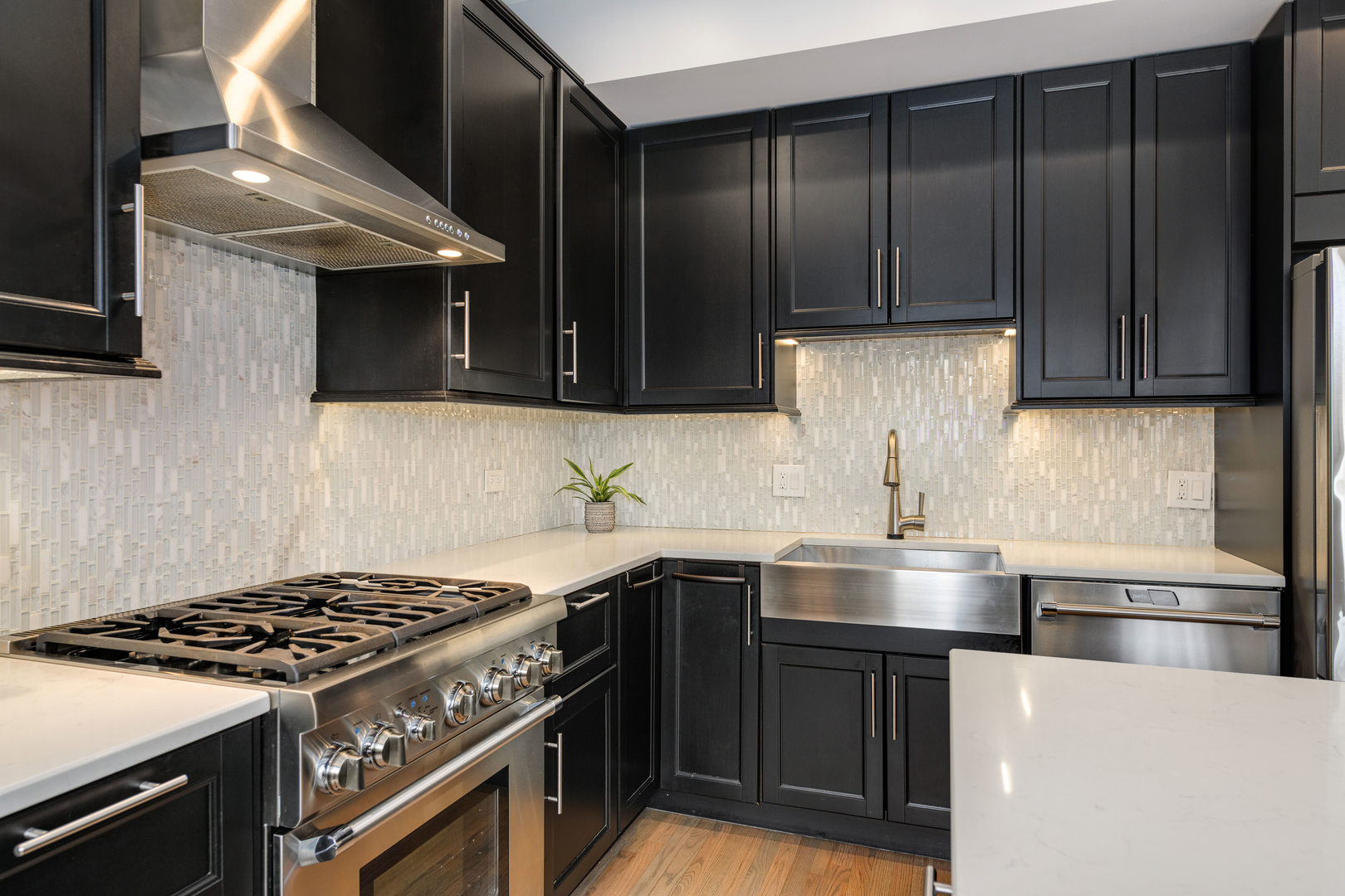 1718 West Huron Street Chicago, IL 60622 - Photo 10 of 33 a kitchen with stainless steel appliances wooden cabinets and a stove top oven