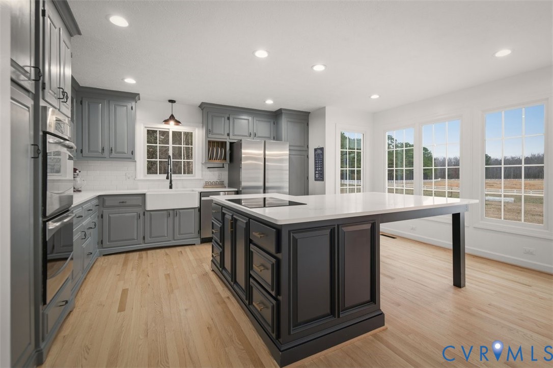 4040 Richmond Road Amelia Court House, VA 23002 - Photo 13 of 50 a large kitchen with kitchen island wooden cabinets and stainless steel appliances