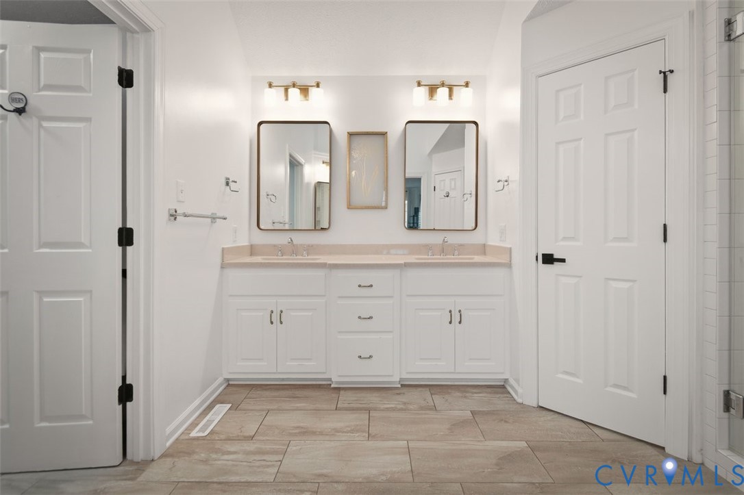 4040 Richmond Road Amelia Court House, VA 23002 - Photo 22 of 50 a bathroom with a double vanity sink and mirror