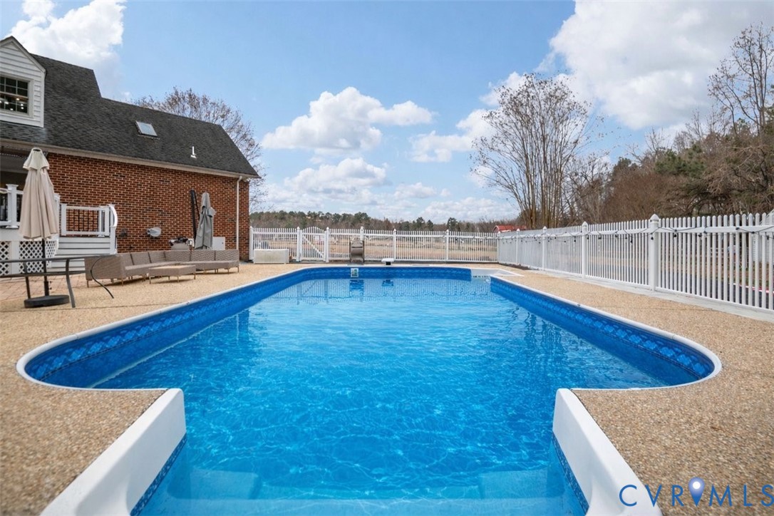 4040 Richmond Road Amelia Court House, VA 23002 - Photo 41 of 50 a view of a swimming pool with an outdoor seating and house in the background
