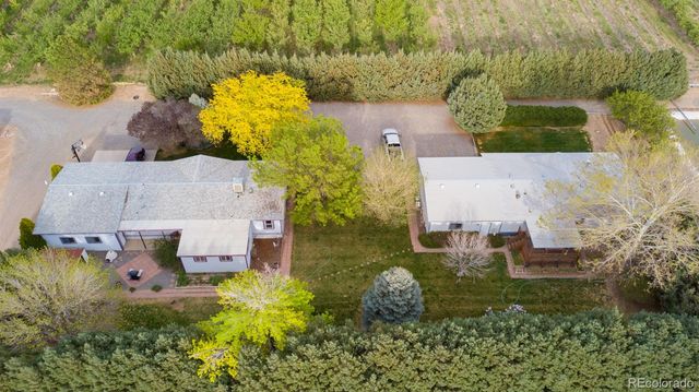 an aerial view of a residential houses with outdoor space and river