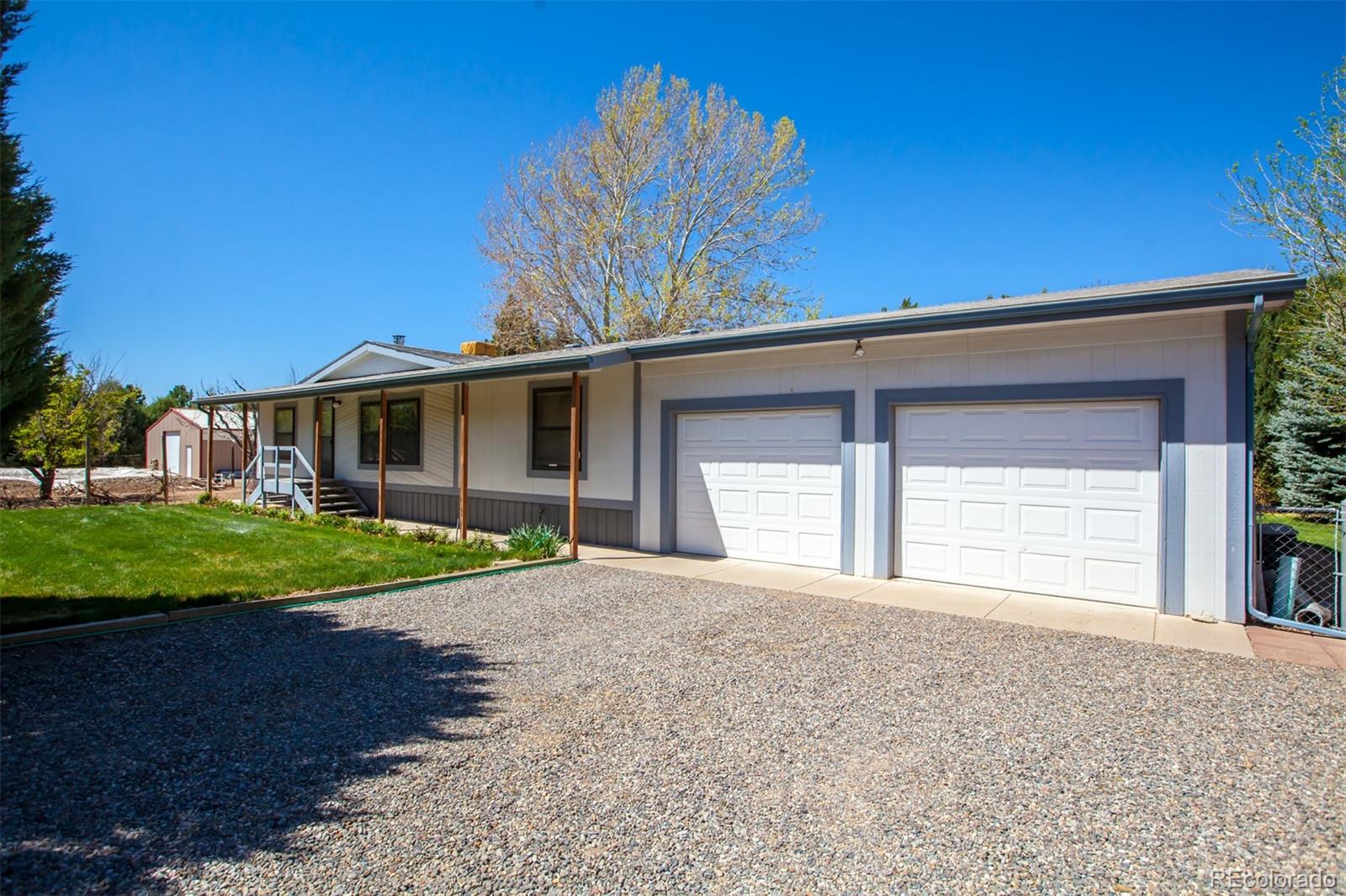3281 C Road Palisade, CO 81526 - Photo 28 of 33 a front view of a house with a yard and garage
