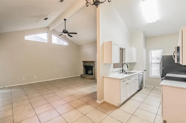 a kitchen with a stove a sink and cabinets