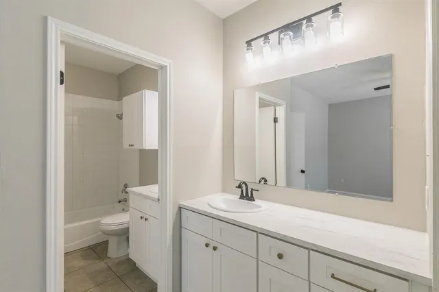 a kitchen with stainless steel appliances a stove a sink a microwave and cabinets