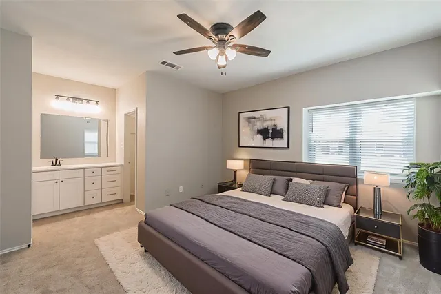 a bedroom with a large bed and a chandelier