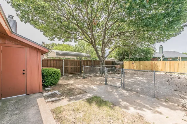 a view of a house with a small yard and plants