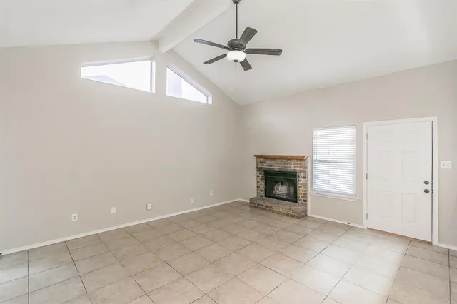 a view of an empty room with a fireplace