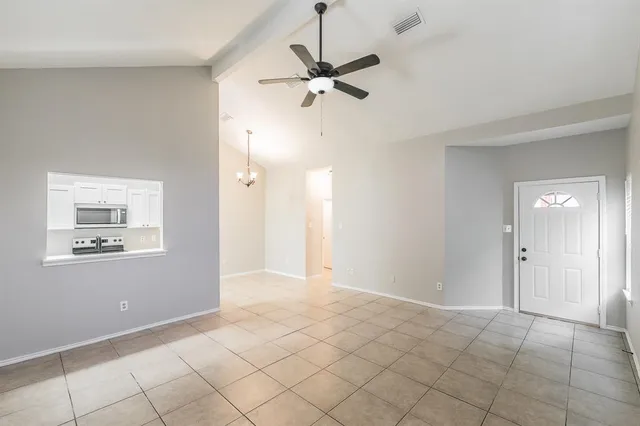 a view of room with window and ceiling fan