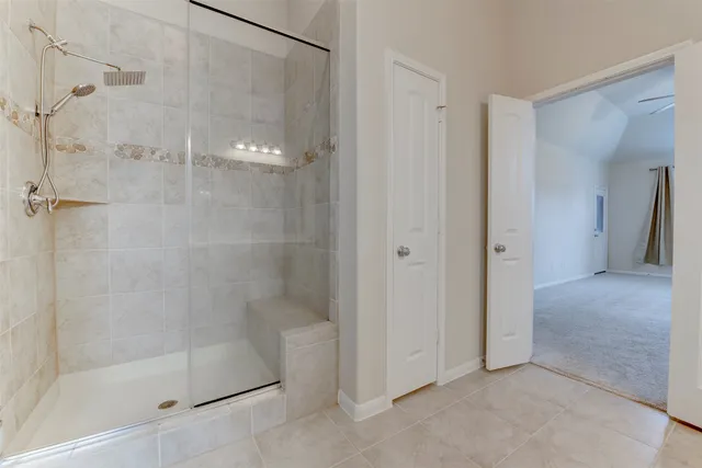 a bathroom with a glass shower door