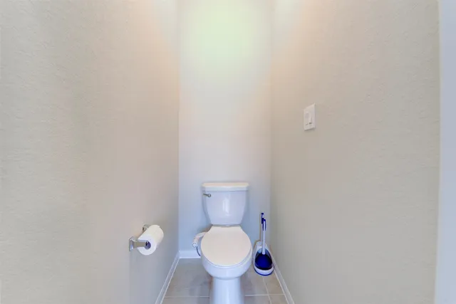 a white toilet sitting in a bathroom