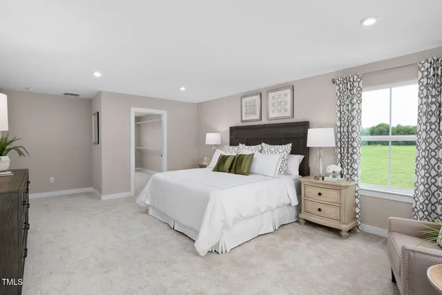 a spacious bedroom with a bed and a couch