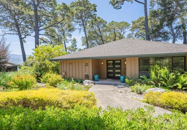 a front view of a house with garden