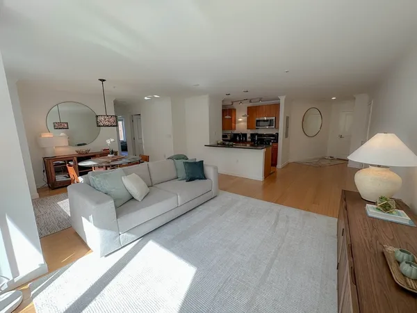 a living room with furniture and a mirror