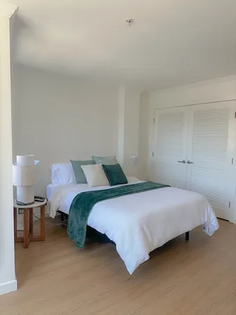 a bedroom with a bed and a lamp