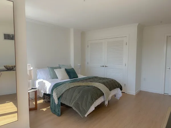 a bedroom with a bed and window