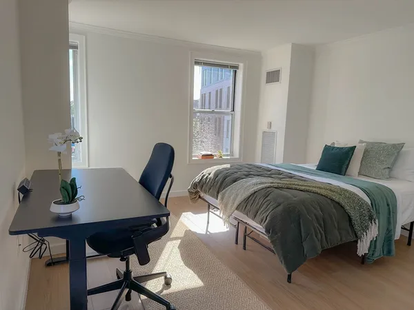 a bedroom with a bed and a table