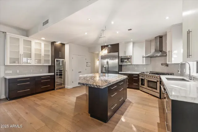 a kitchen with stainless steel appliances granite countertop a stove and a sink