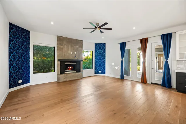 a view of an empty room with a fireplace and a window