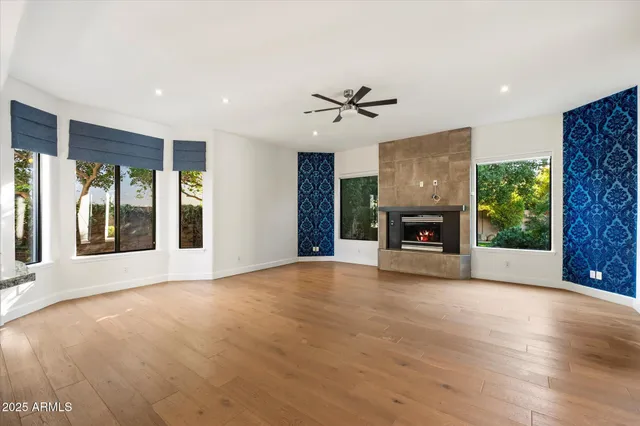a view of an empty room with a fireplace and a window