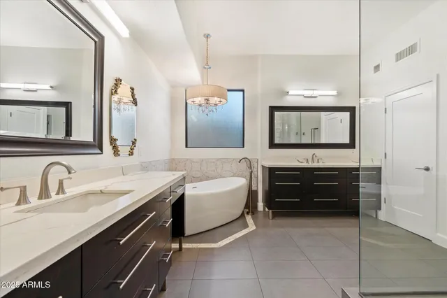 a en suite bathroom with a sink and a mirror