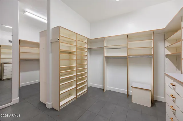 a view of walk in closet with empty racks