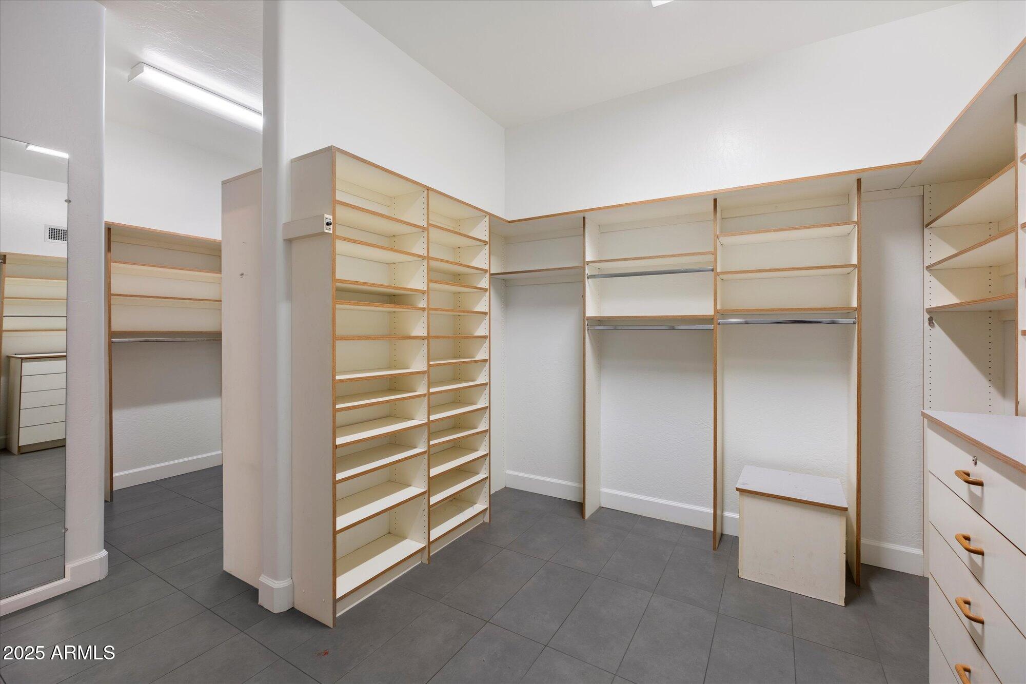 11 West San Juan Avenue Phoenix, AZ 85013 - Photo 25 of 40 a view of walk in closet with empty racks