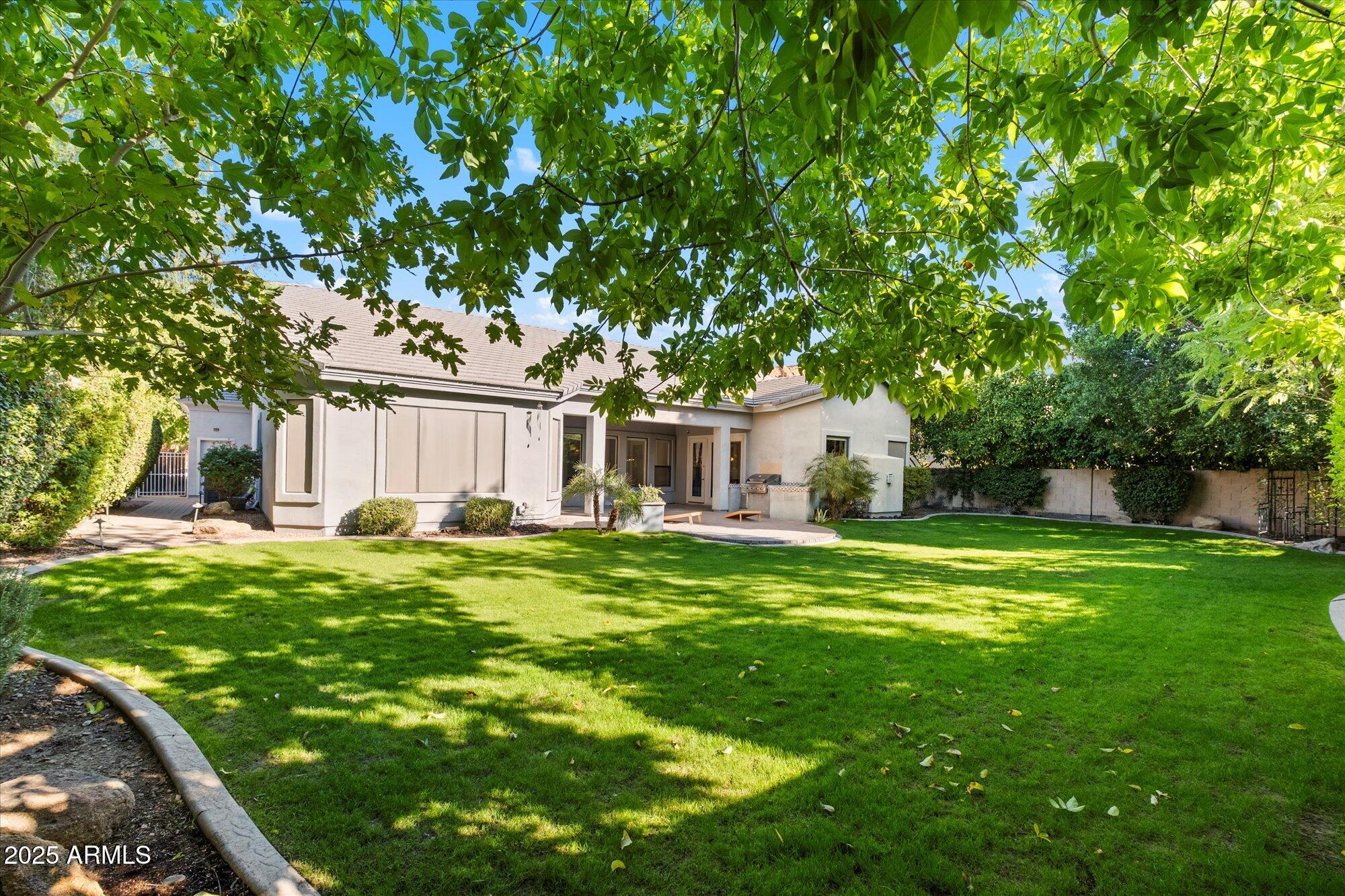 11 West San Juan Avenue Phoenix, AZ 85013 - Photo 38 of 40 a front view of a house with a garden and trees
