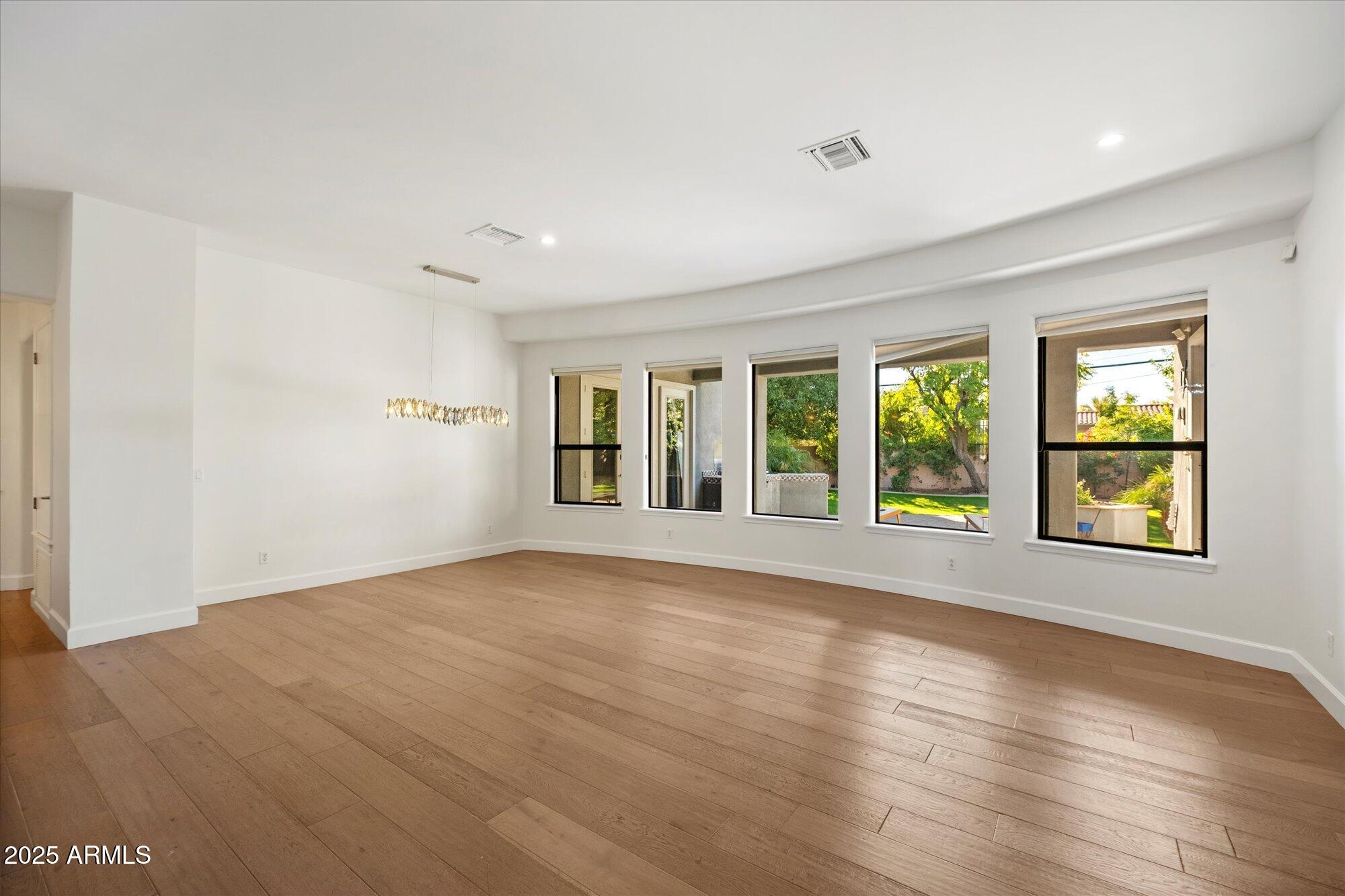 11 West San Juan Avenue Phoenix, AZ 85013 - Photo 7 of 40 a view of an empty room with wooden floor and a window