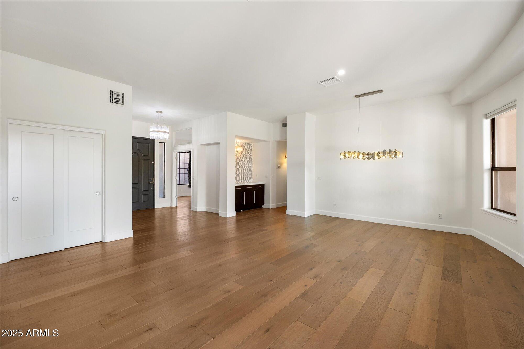 11 West San Juan Avenue Phoenix, AZ 85013 - Photo 8 of 40 a view of an empty room with a window and a kitchen