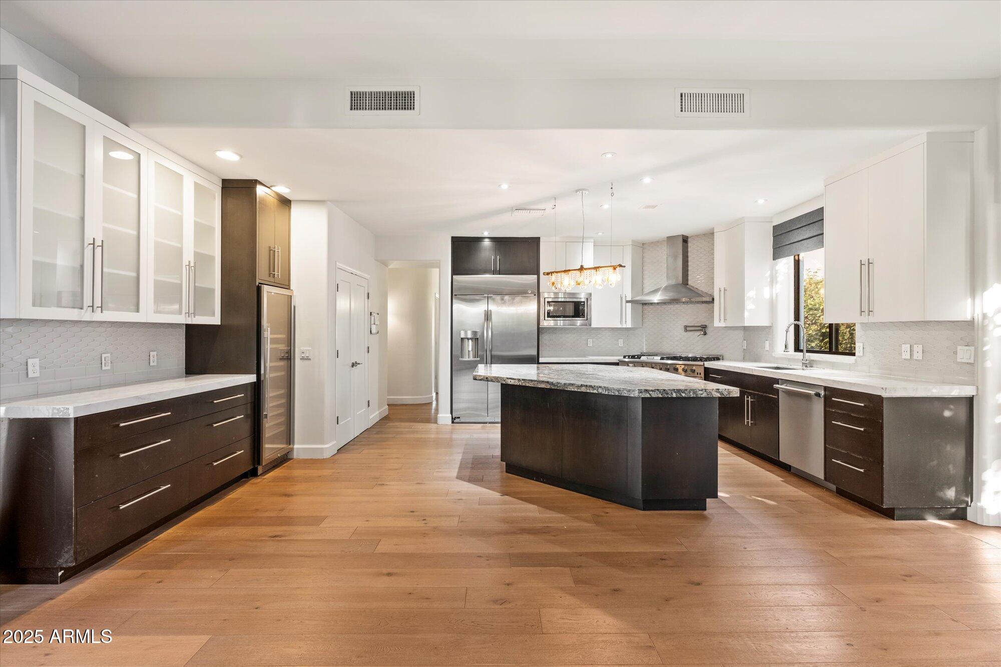 11 West San Juan Avenue Phoenix, AZ 85013 - Photo 10 of 40 a large kitchen with stainless steel appliances granite countertop a stove refrigerator and a sink