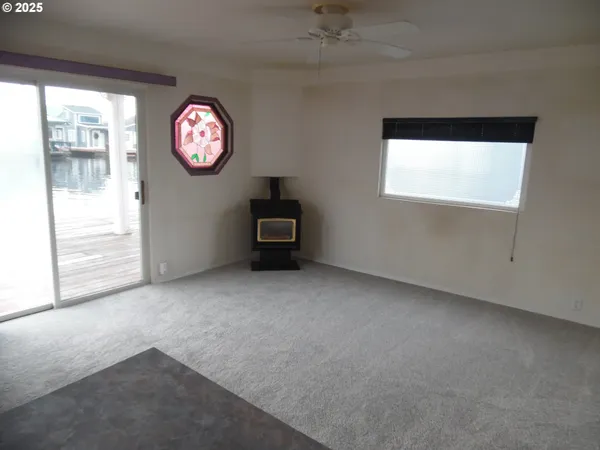 a living room with furniture a rug and a window