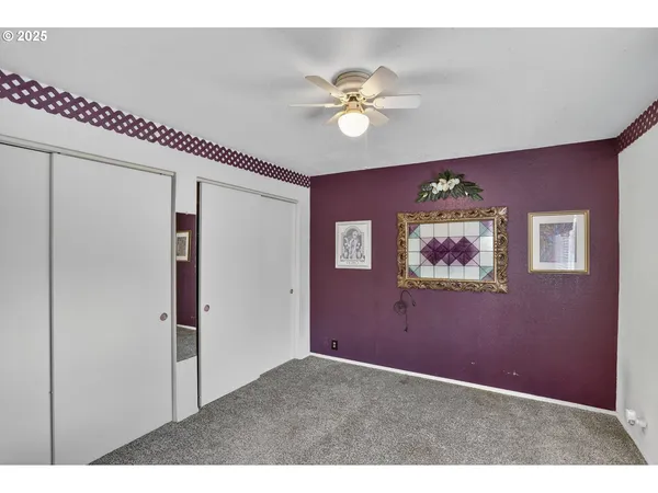 a view of a livingroom with furniture and chandelier fan