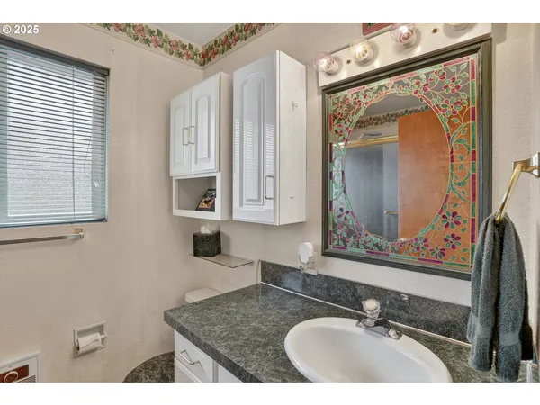 a bathroom with double vanity sink and a mirror