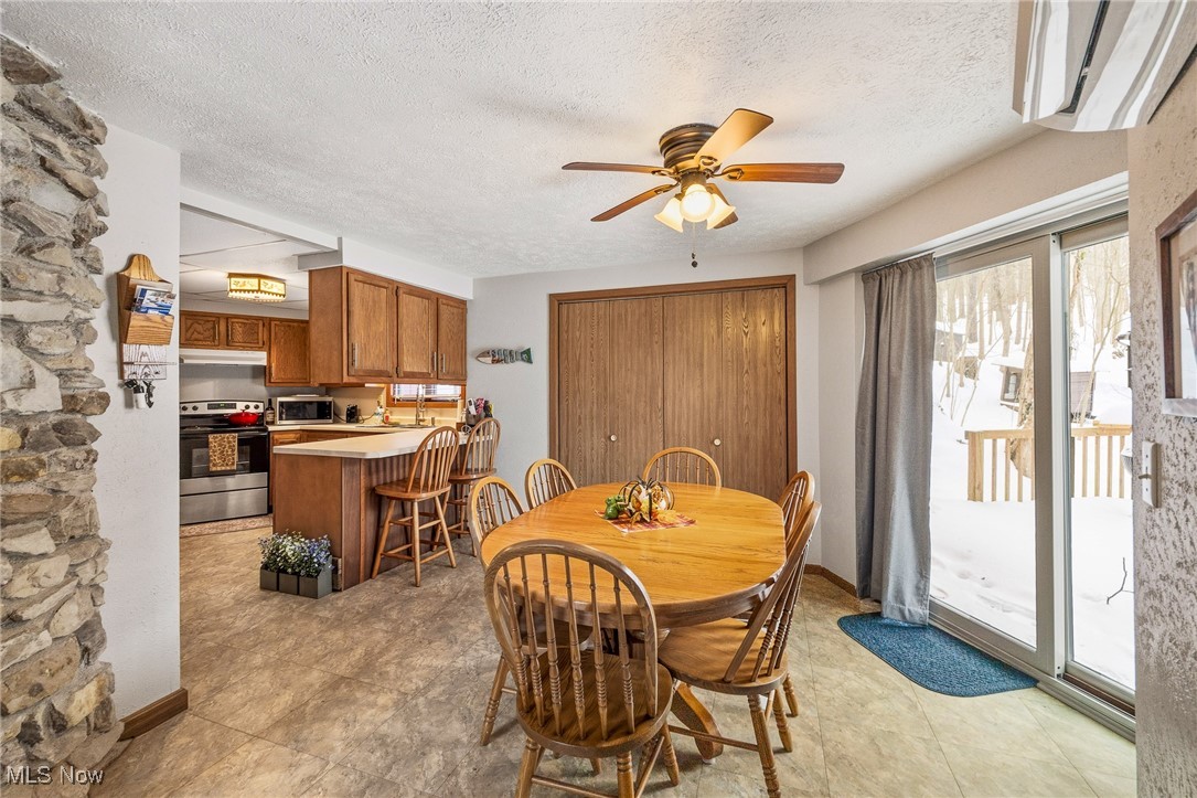 86523 North Bay Road Scio, OH 43988 - Photo 7 of 25 Dining room featuring ceiling fan and a textured ceiling